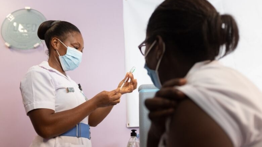 a-nurse-sits-while-awaiting-a-covid-19-vaccination-in-accra-ghana